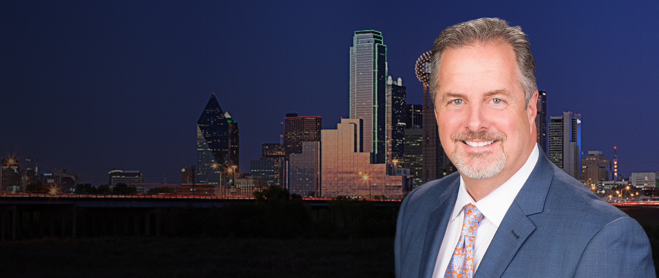 Attorney Bryan T. Forman with the city skyline in the background