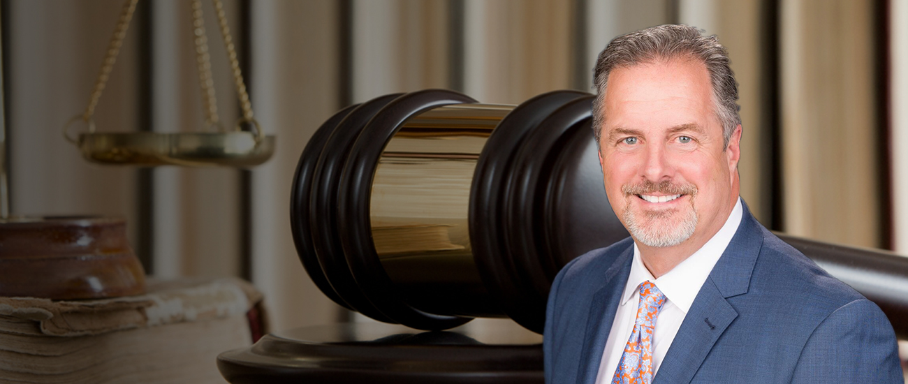 Attorney Bryan T. Forman stands next to a gavel