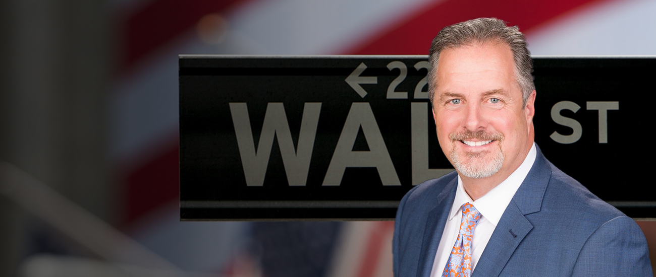 Attorney Bryan T. Forman with a Wall Street sign in the background